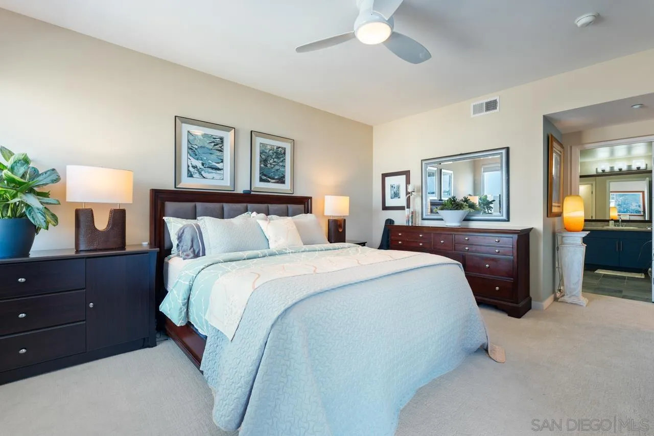 3650 Fifth Avenue, Unit 614 San Diego, CA 92103 - Photo 35 of 62 a bedroom with a bed and a chandelier