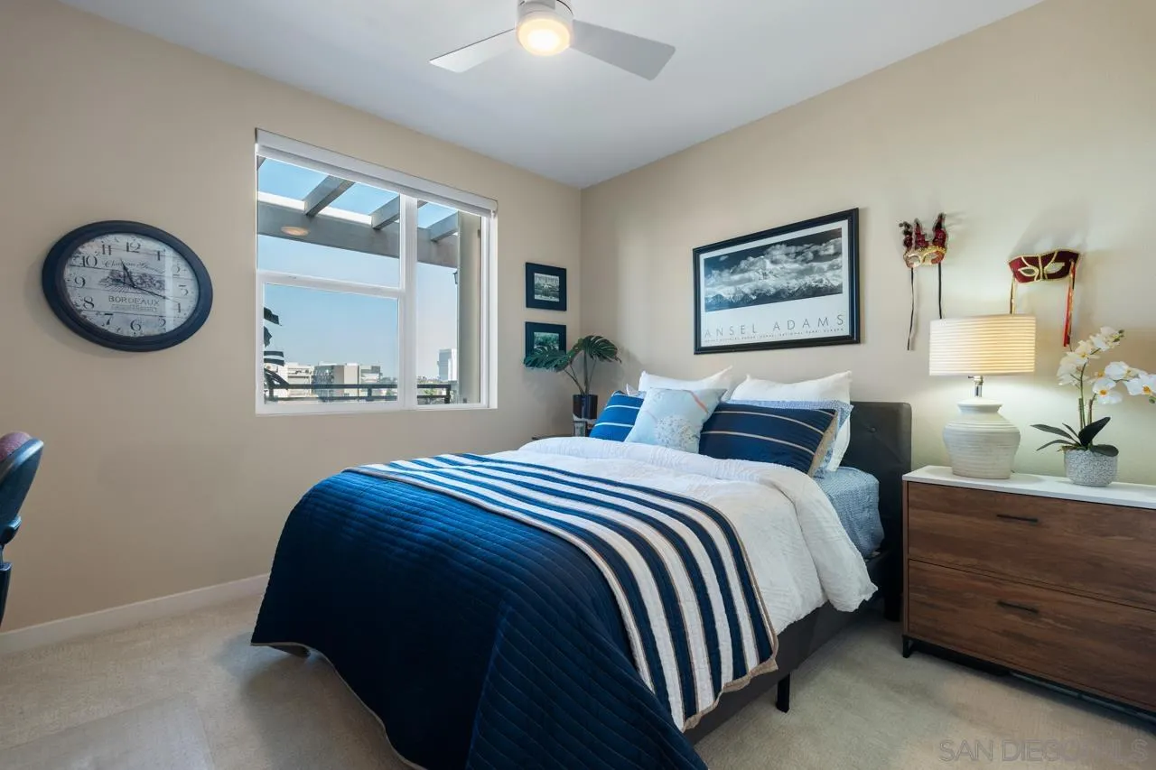 3650 Fifth Avenue, Unit 614 San Diego, CA 92103 - Photo 44 of 62 a bedroom with a bed and a painting on the wall
