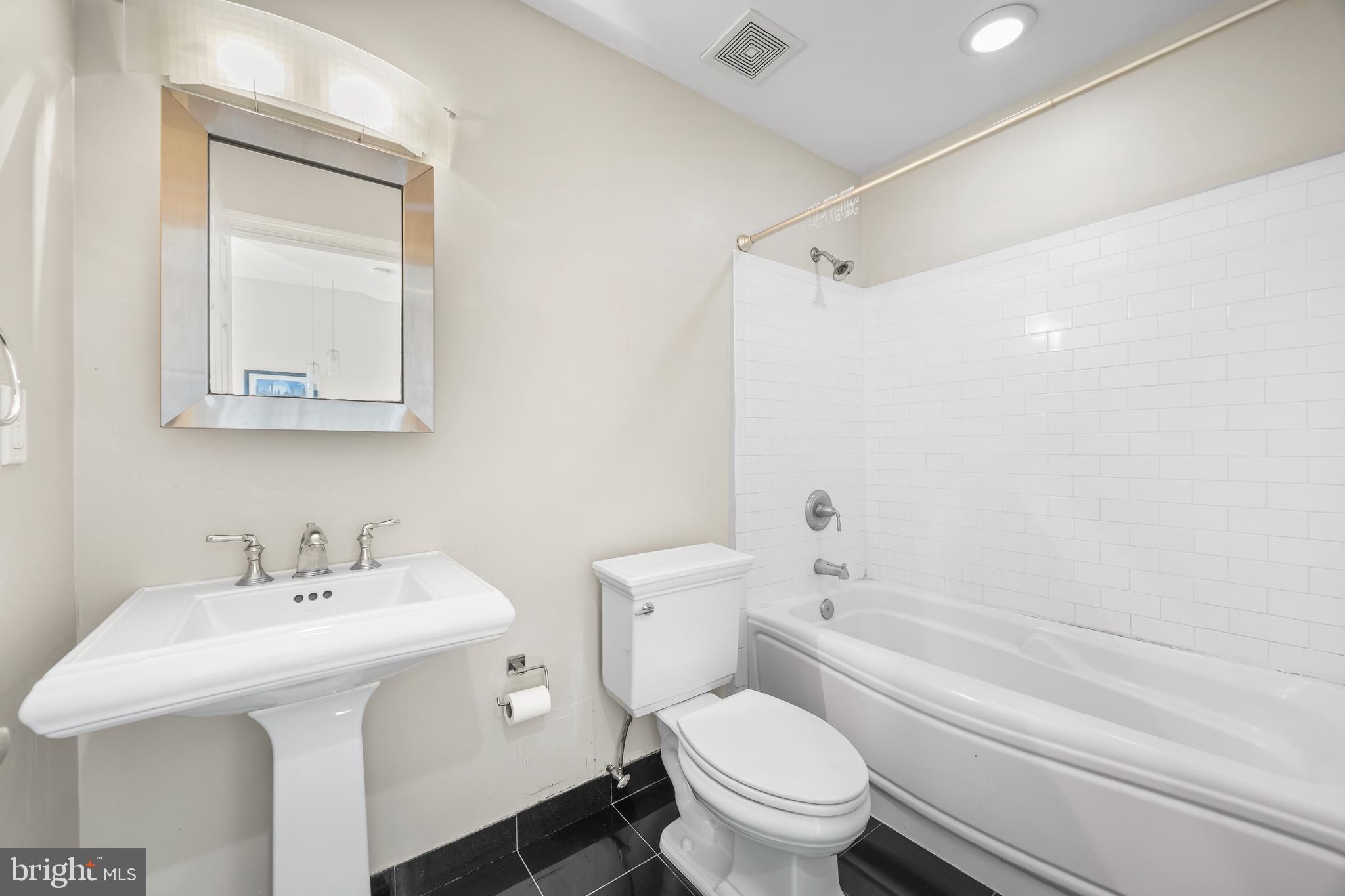 1011 Hunter Street, Unit F4 Baltimore, MD 21202 - Photo 11 of 19 a bathroom with a sink toilet and shower