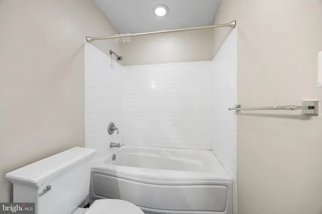 a bathroom with a bathtub and a toilet
