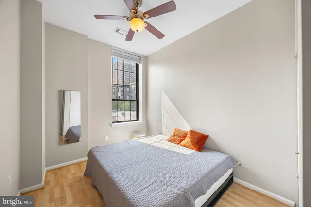 a bedroom with a bed and a window