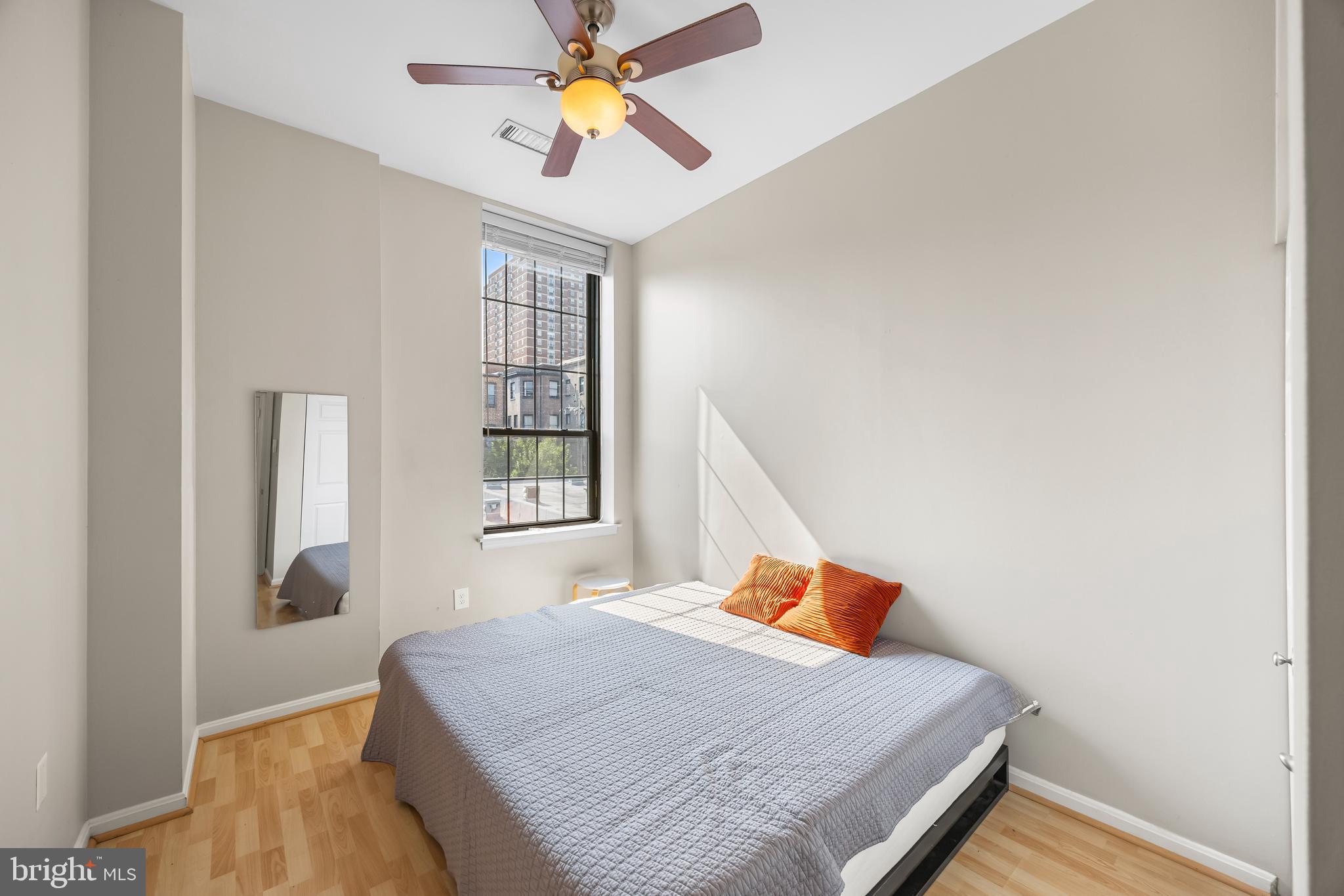 1011 Hunter Street, Unit F4 Baltimore, MD 21202 - Photo 13 of 19 a bedroom with a bed and a window