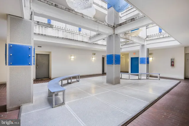 a lobby with furniture and mirror