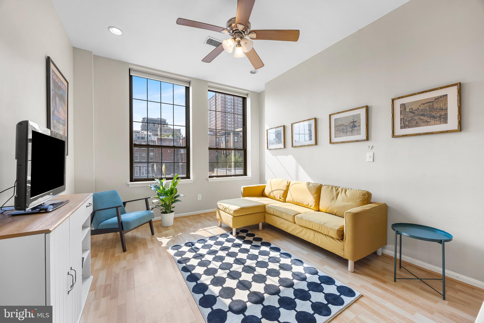 1011 Hunter Street, Unit F4 Baltimore, MD 21202 - Photo 2 of 19 a living room with furniture a flat screen tv and a window