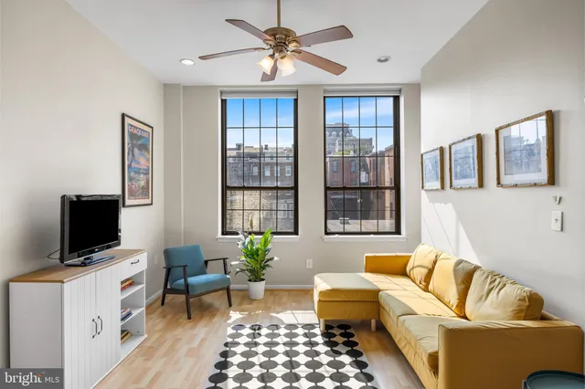 a living room with furniture and a flat screen tv