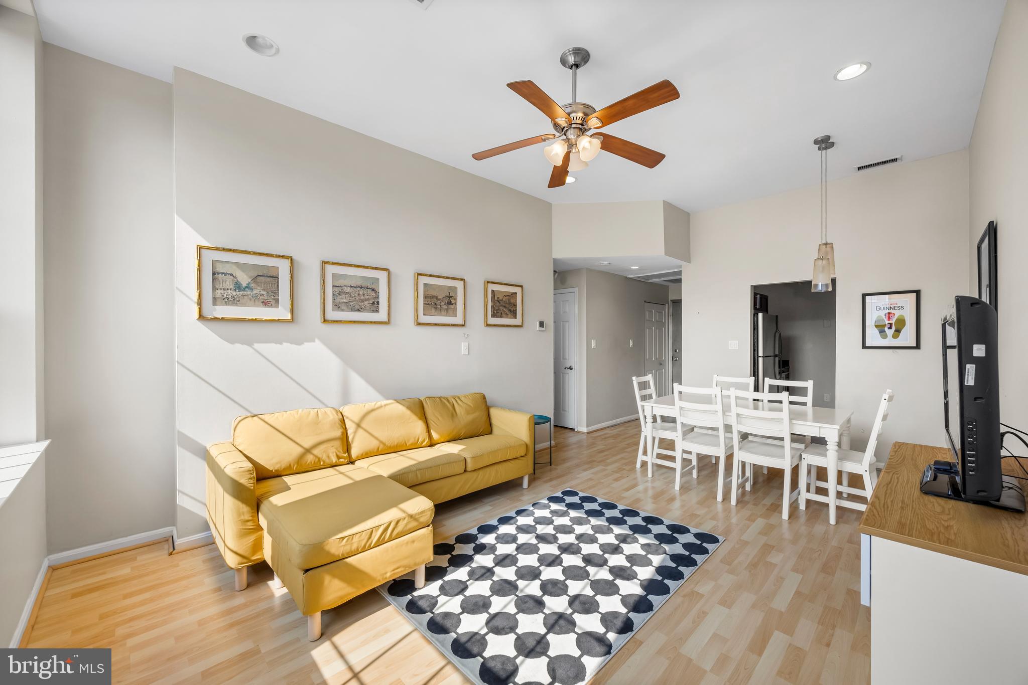 1011 Hunter Street, Unit F4 Baltimore, MD 21202 - Photo 4 of 19 a living room with furniture kitchen view and a wooden floor