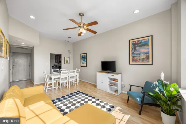 a living room with furniture a window and a flat screen tv