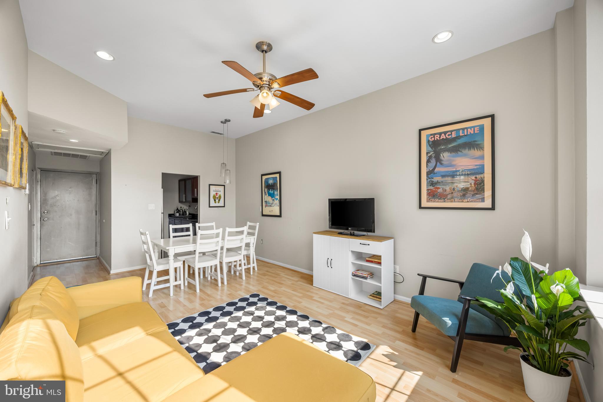 1011 Hunter Street, Unit F4 Baltimore, MD 21202 - Photo 5 of 19 a living room with furniture a window and a flat screen tv