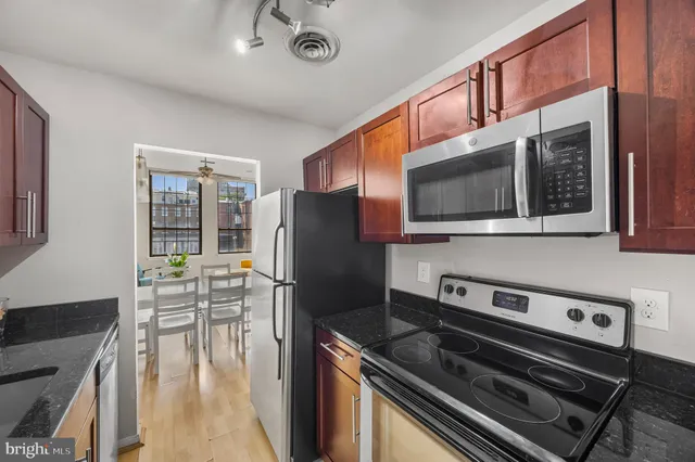 a kitchen with stainless steel appliances a stove a microwave and a refrigerator