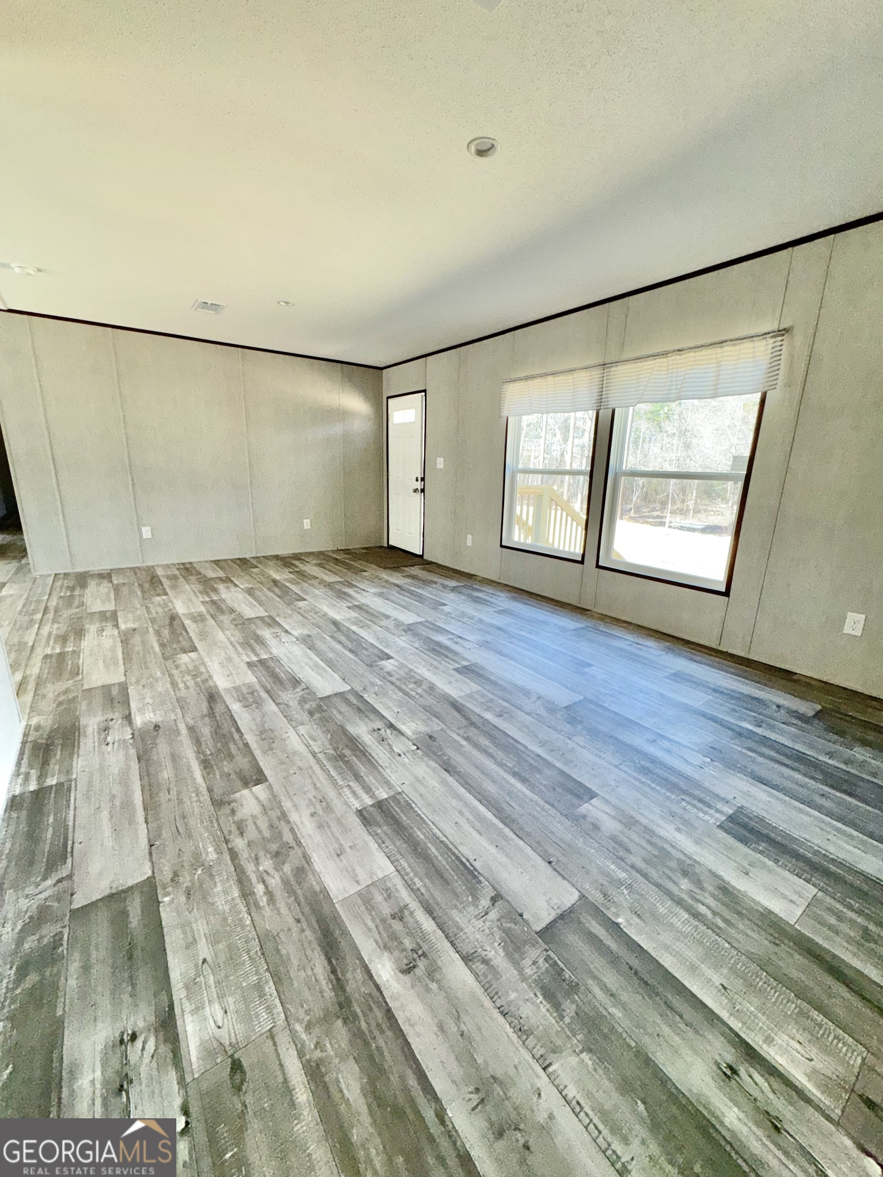 420 Mosley Bridge Road Claxton, GA 30417 - Photo 13 of 23 a view of an empty room with wooden floor and a window
