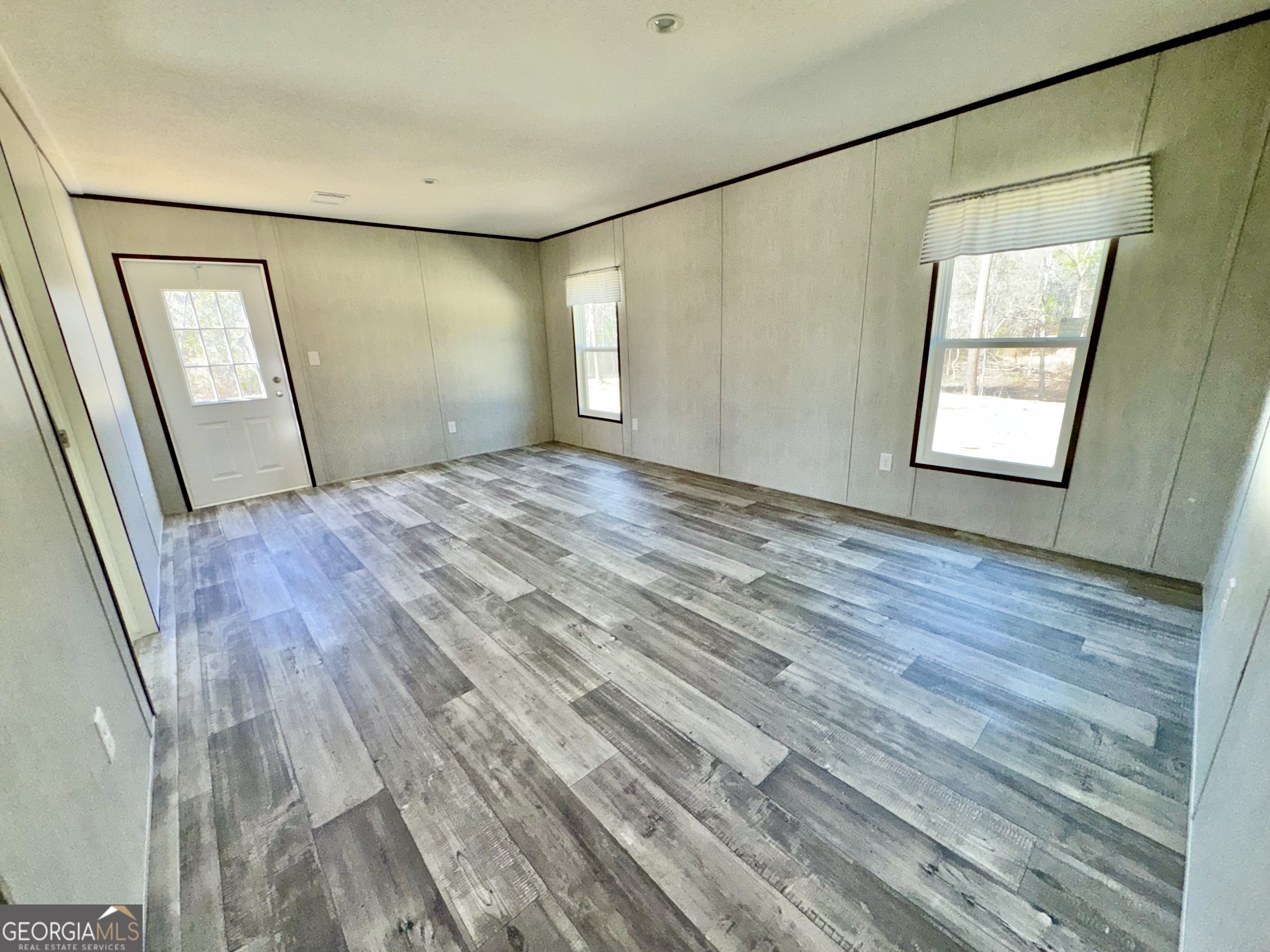 420 Mosley Bridge Road Claxton, GA 30417 - Photo 18 of 23 a view of an empty room with wooden floor and a window