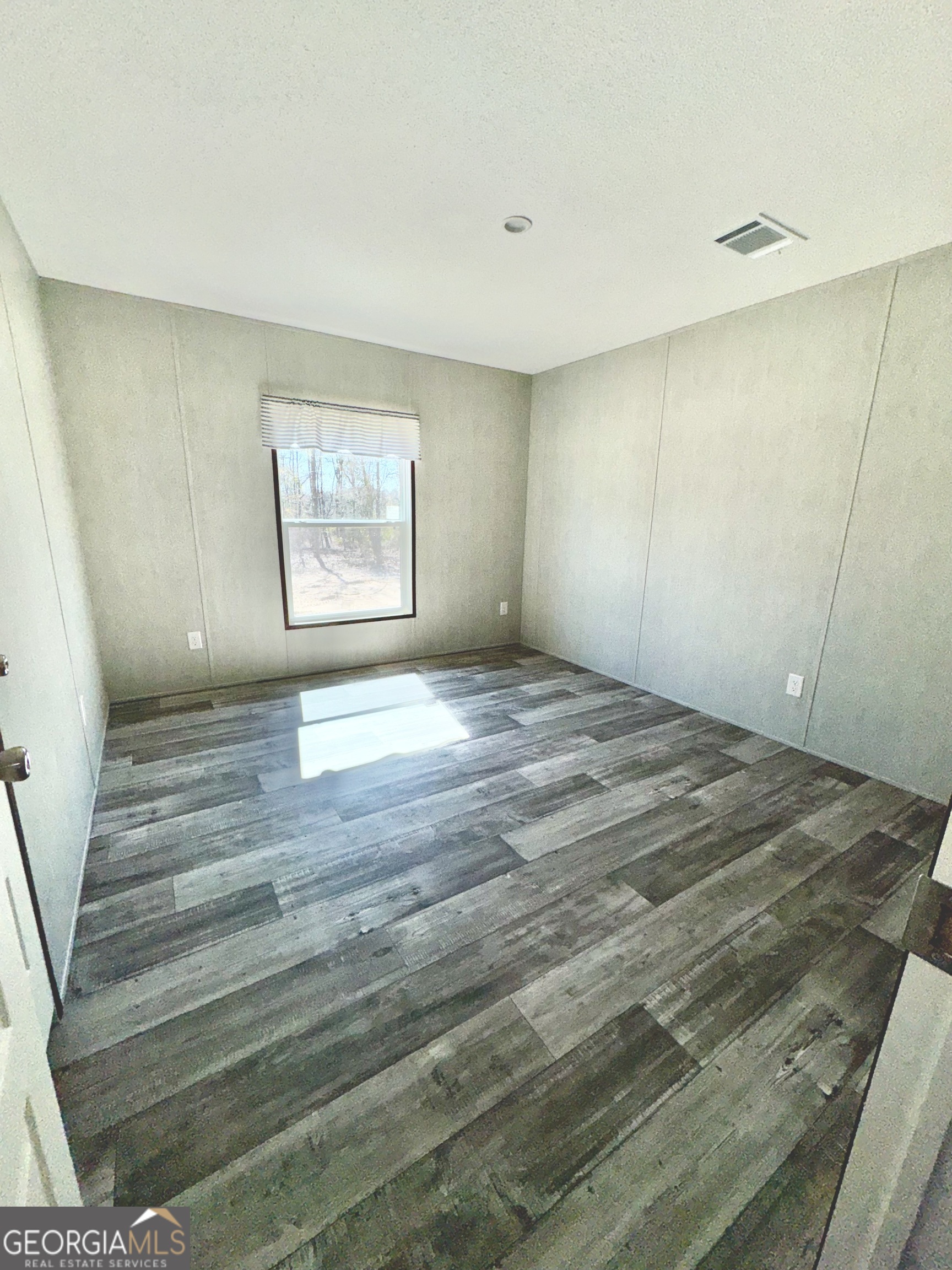 420 Mosley Bridge Road Claxton, GA 30417 - Photo 19 of 23 a view of an empty room with window and hardwood floor
