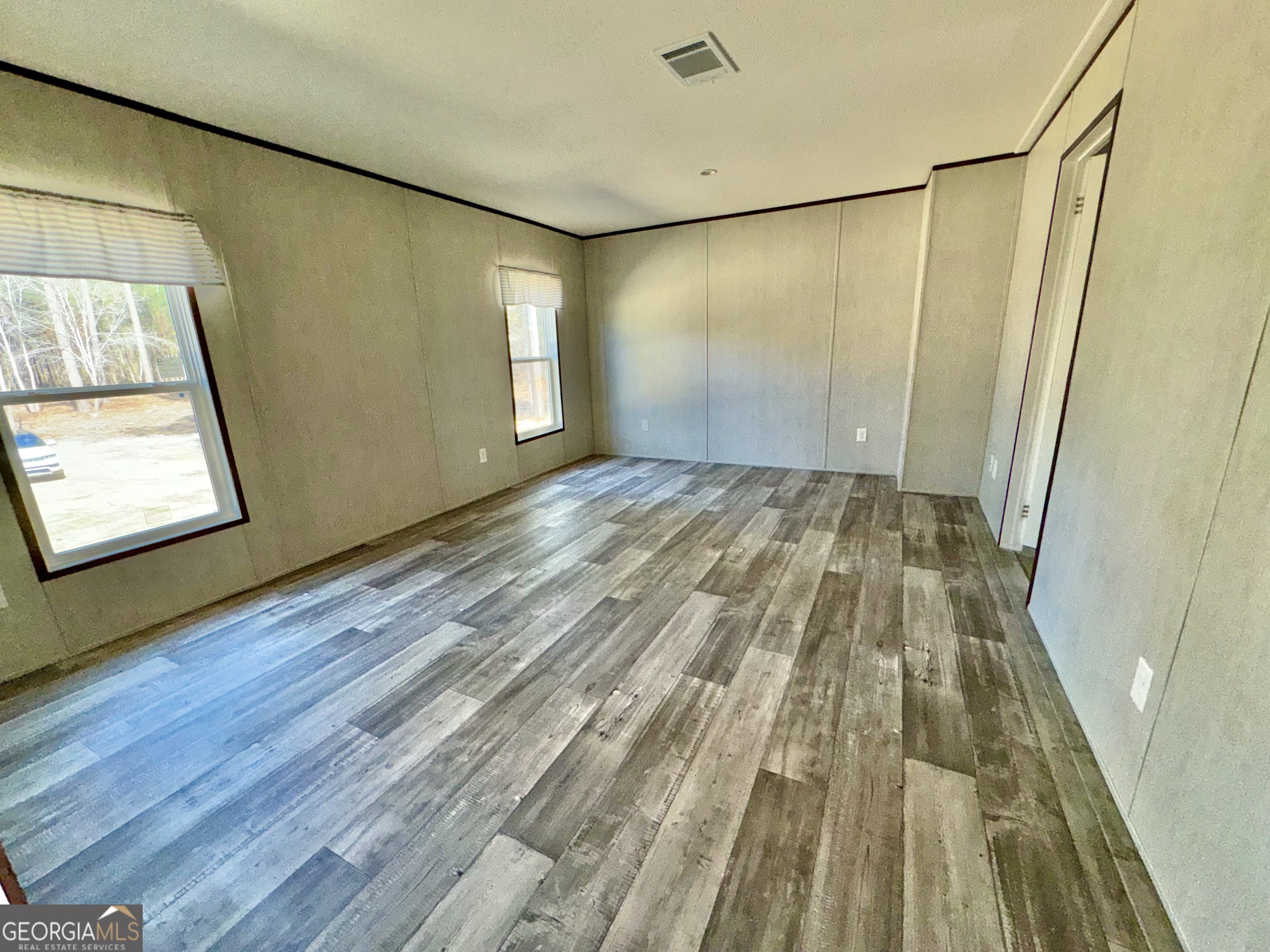 420 Mosley Bridge Road Claxton, GA 30417 - Photo 20 of 23 a view of an empty room with wooden floor and a window