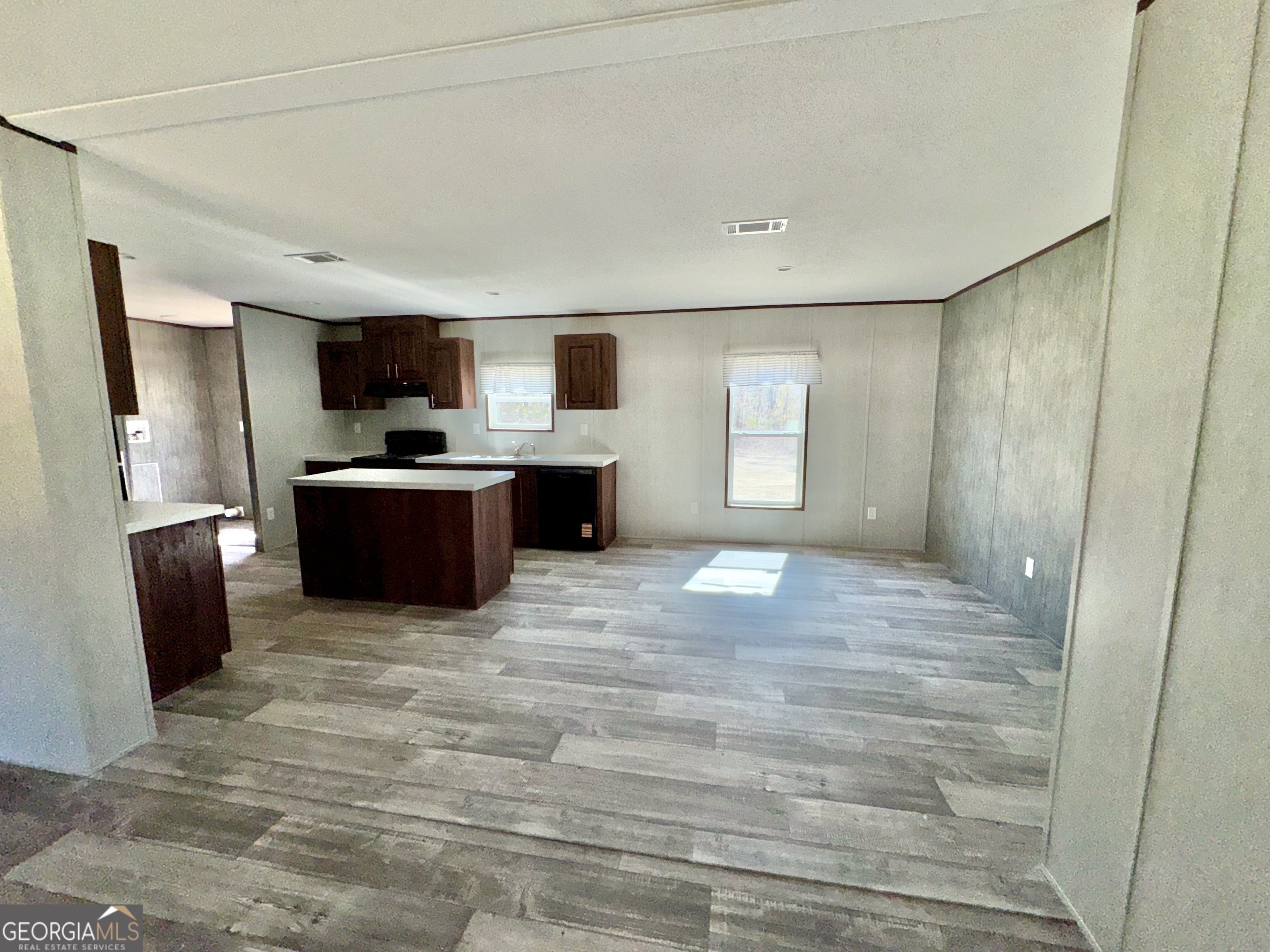 420 Mosley Bridge Road Claxton, GA 30417 - Photo 22 of 23 a view of kitchen with stainless steel appliances wooden floor and window