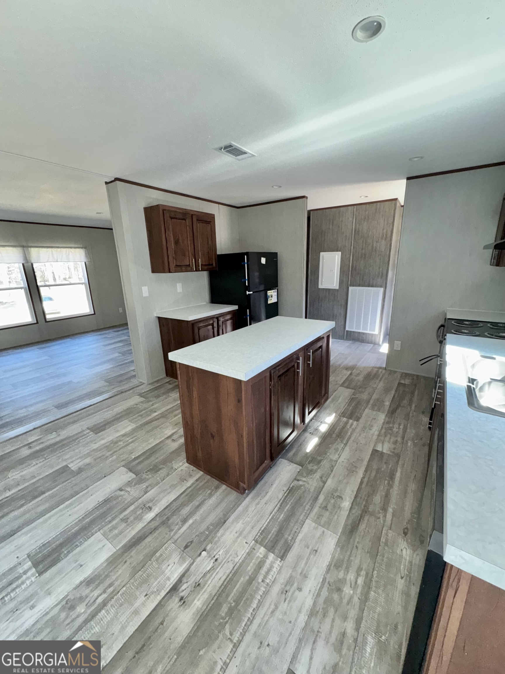420 Mosley Bridge Road Claxton, GA 30417 - Photo 5 of 23 a living room with stainless steel appliances kitchen island hardwood floor and a sink