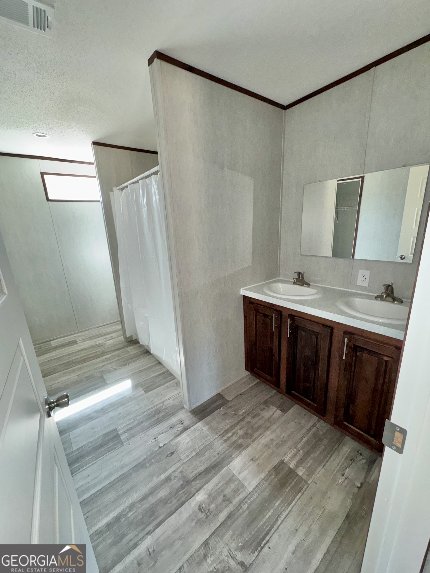 420 Mosley Bridge Road Claxton, GA 30417 - Photo 8 of 23 a bathroom with a double vanity sink and a mirror