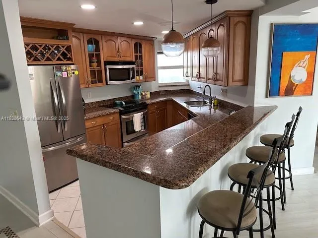 a kitchen with stainless steel appliances granite countertop a sink stove and microwave