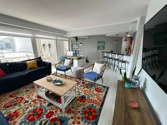a living room with furniture rug and window