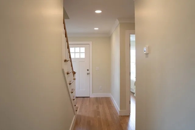 a view of an entryway with wooden floor