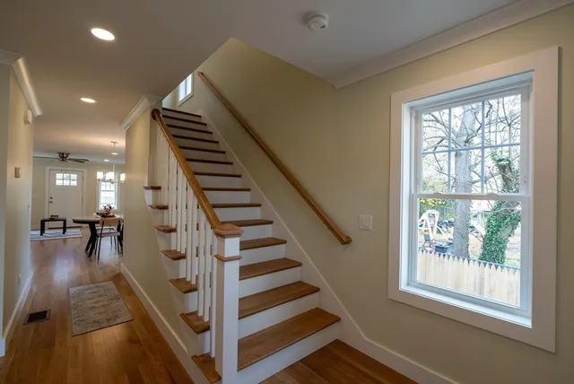 a view of entryway and hall with wooden floor
