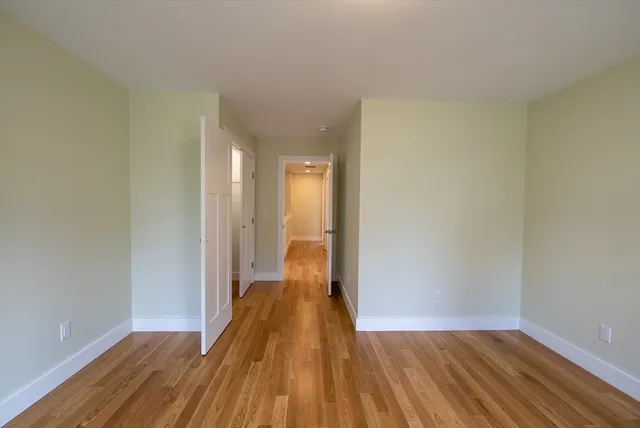 a view of a room with wooden floor