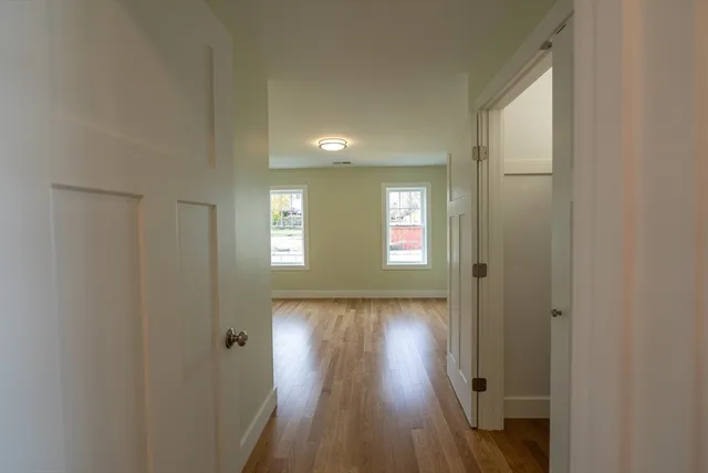 a view of hallway with wooden floor