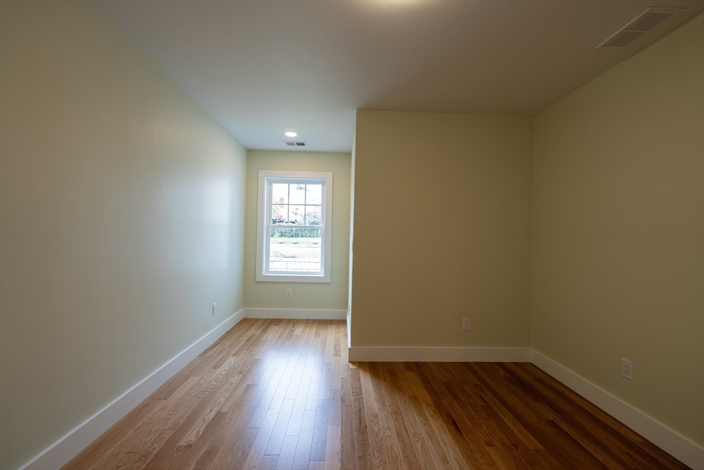 159 State Street New Bedford, MA 02740 - Photo 20 of 30 an empty room with wooden floor and windows