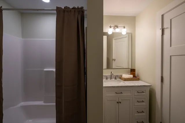 a bathroom with a double vanity sink and mirror
