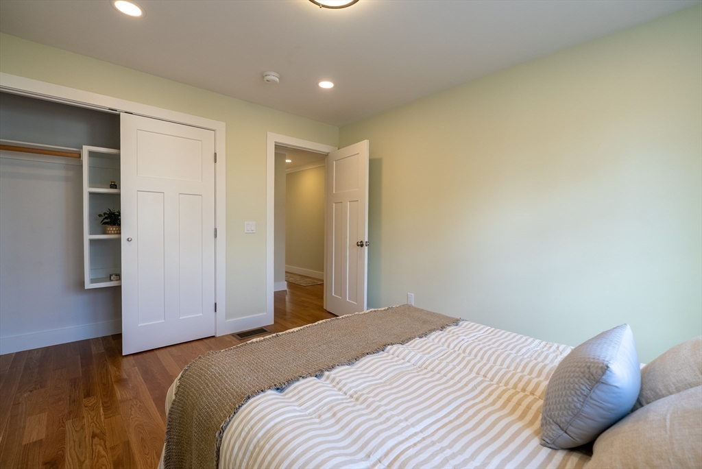 159 State Street New Bedford, MA 02740 - Photo 10 of 30 a bedroom with a bed and a cabinets