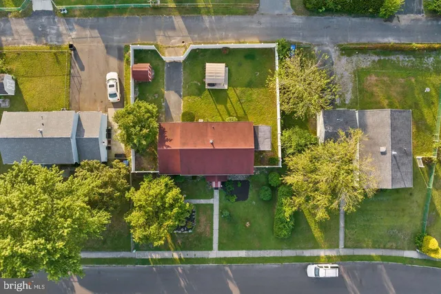 an aerial view of a house with a yard basket ball court and outdoor seating