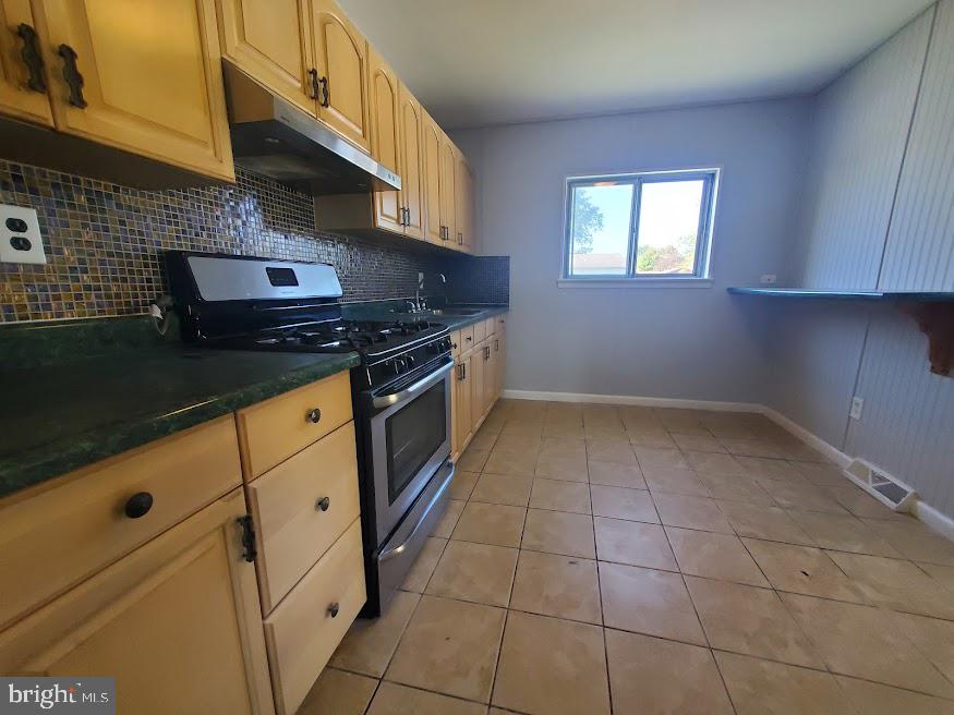 219 Harvard Avenue Pemberton, NJ 08068 - Photo 7 of 42 a kitchen with granite countertop a stove a sink and a microwave