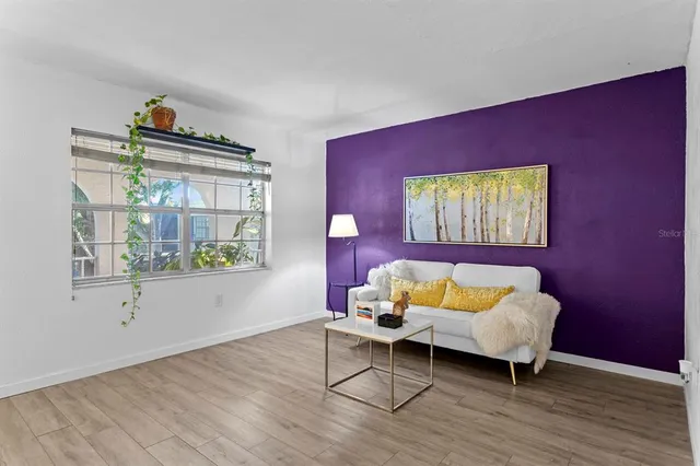 a living room with furniture and a potted plant