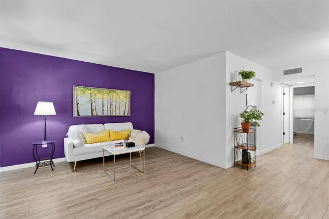 a view of a workspace with furniture and wooden floor