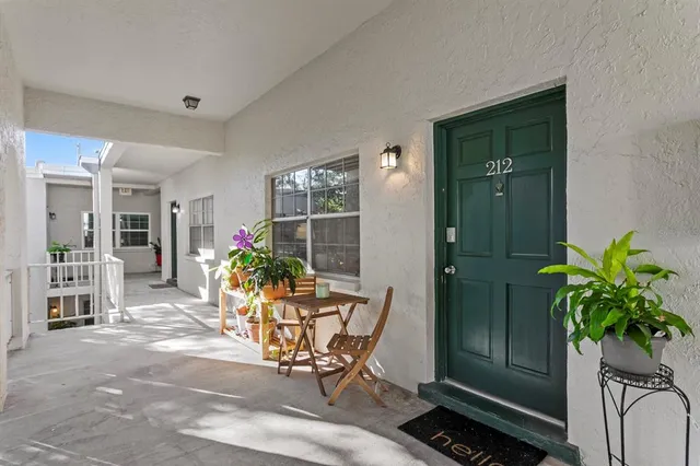 a living room filled with furniture and potted plant