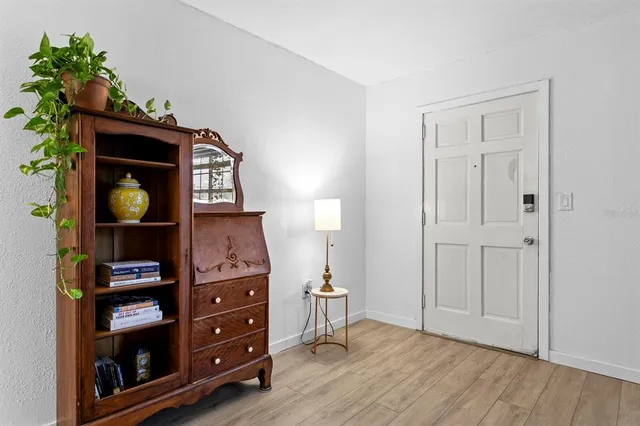 a view of a white house with fountain in front of retail shops