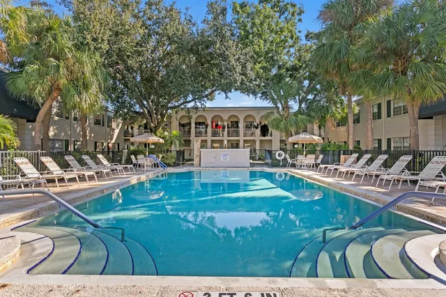 a view of a swimming pool with chairs
