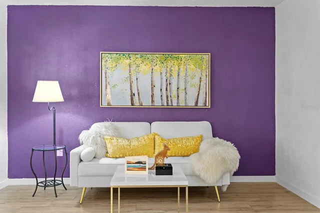 a living room with furniture and a lamp