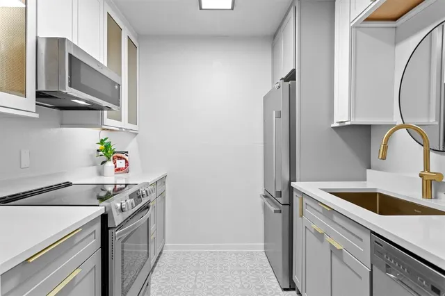 a kitchen with a sink and a mirror