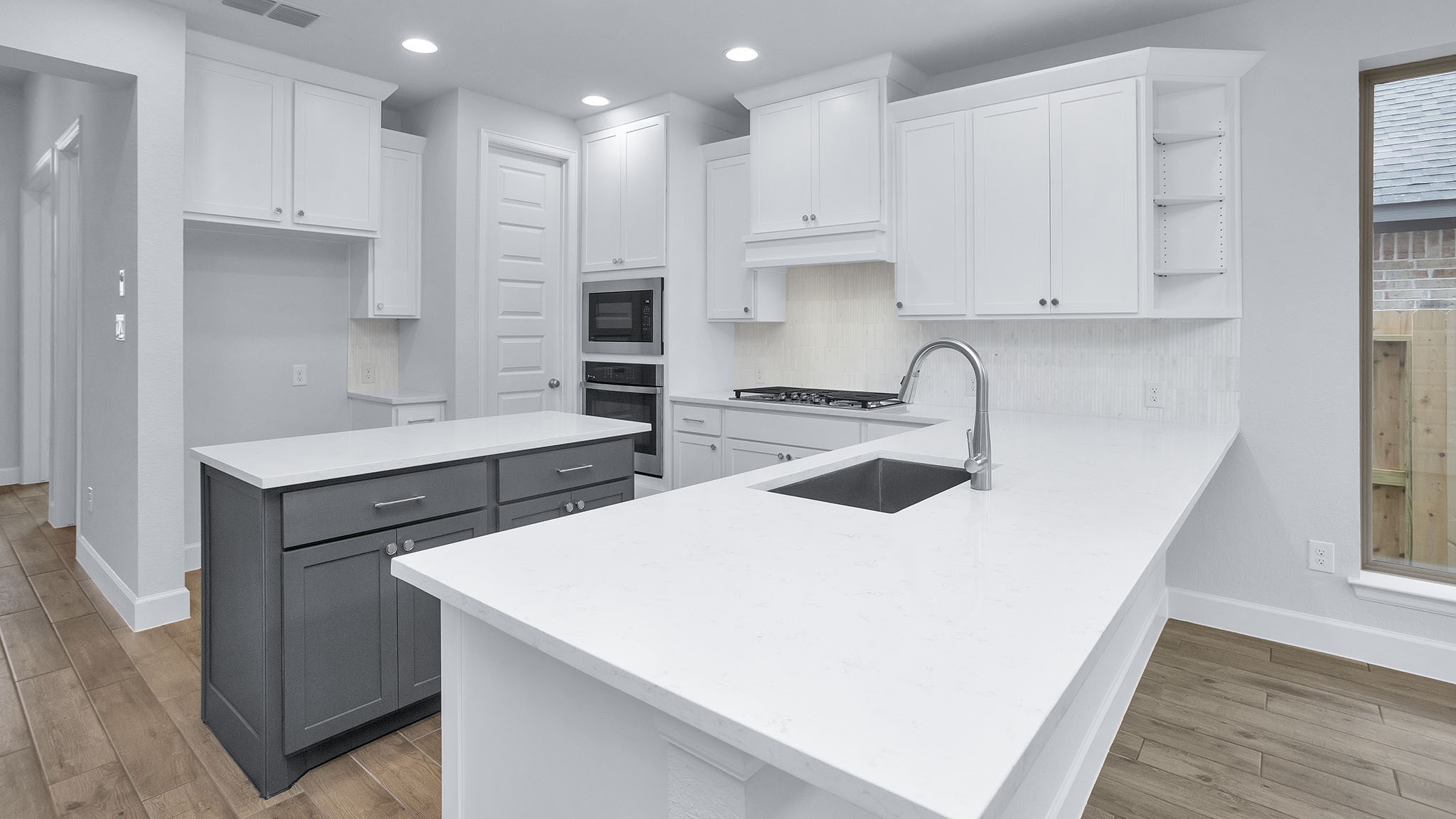 9620 Mount Brewer Lane Porter, TX 77365 - Photo 11 of 25 a kitchen with a sink a stove a refrigerator and white cabinets