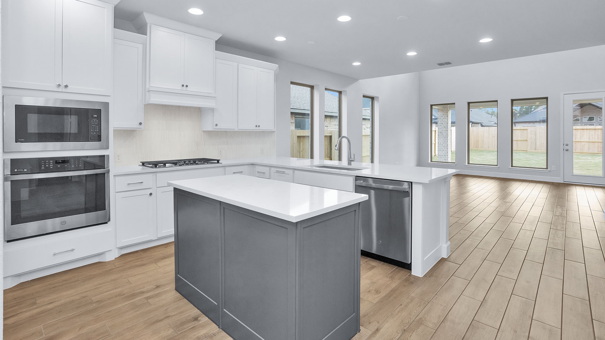 9620 Mount Brewer Lane Porter, TX 77365 - Photo 6 of 25 a kitchen with stainless steel appliances granite countertop a stove a sink and a microwave