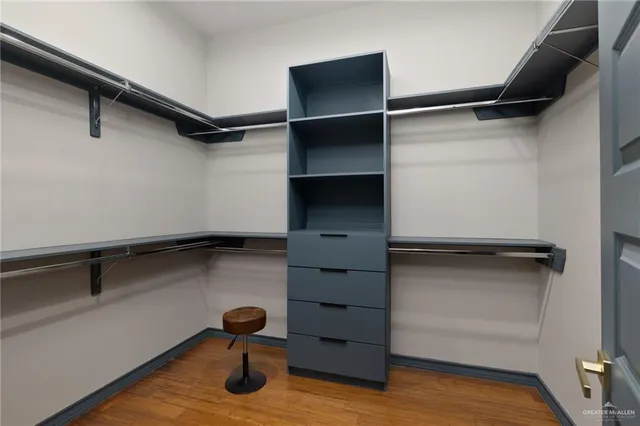 a view of walk in closet with empty racks