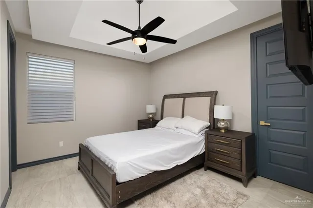 a bedroom with a bed and a chandelier