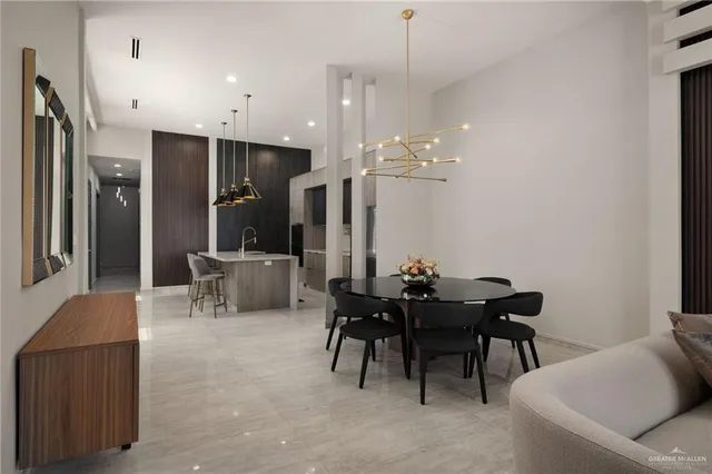 a view of a dining room with furniture and chandelier