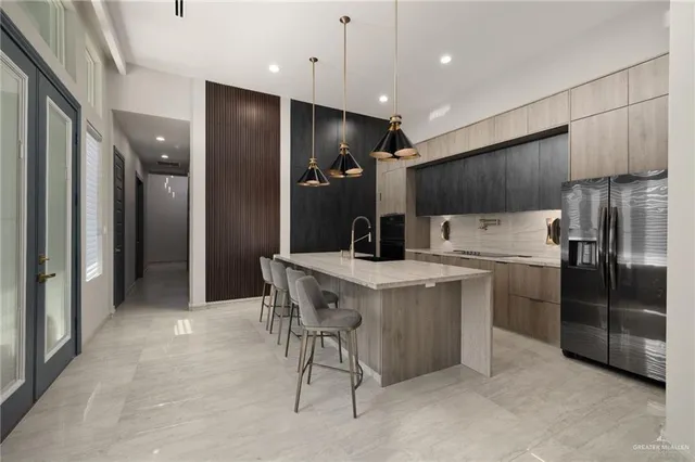 a kitchen with stainless steel appliances a refrigerator and a sink