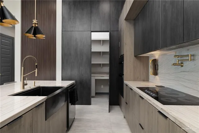 a kitchen with a sink stove and refrigerator