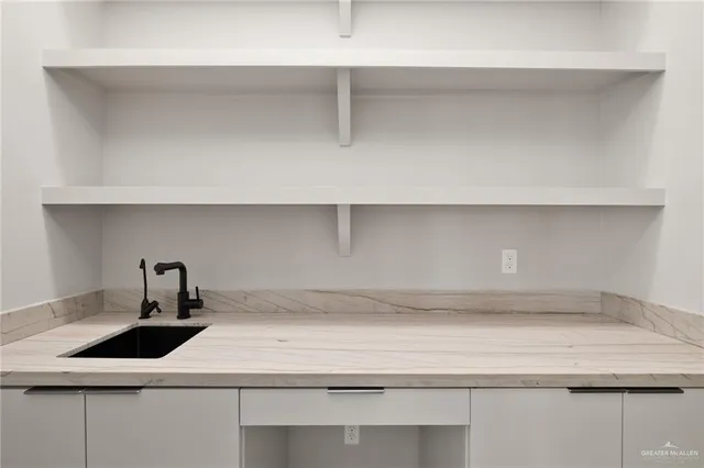 a kitchen with a sink and cabinets