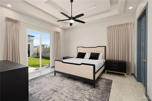 a bedroom with a bed and a large window