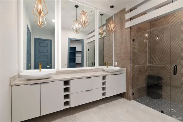 a bathroom with a double vanity sink mirror and bathtub