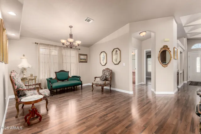 a living room with furniture and a chandelier