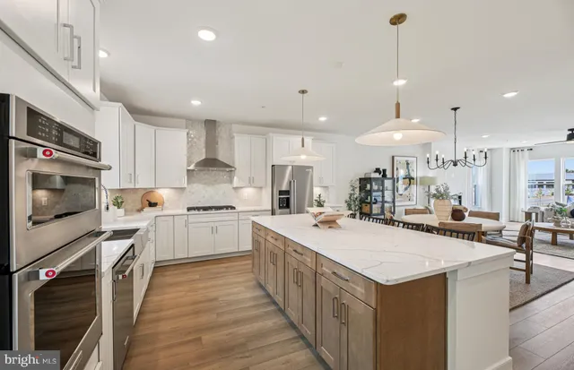 a kitchen with a stove a sink and a refrigerator